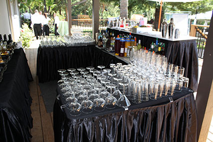 Massive bar setup with glassware at outdoor event