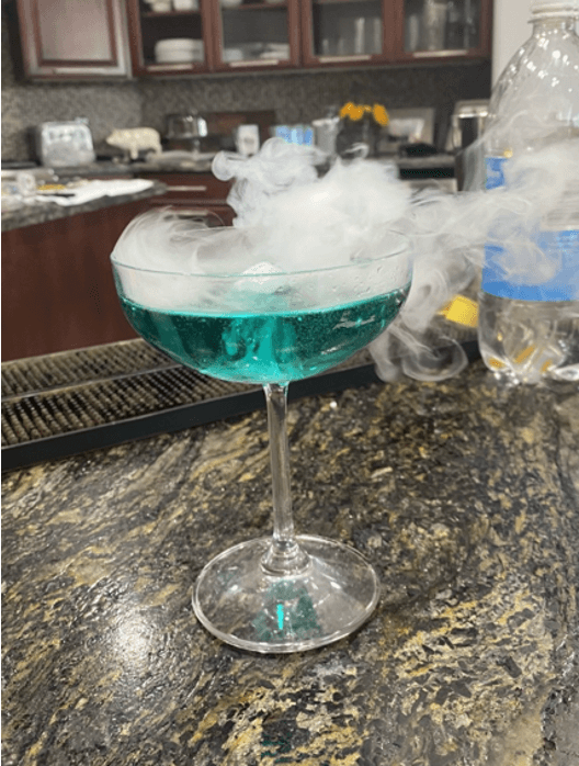 Casino party blue cocktail with smoke rising out of it in Austin, TX