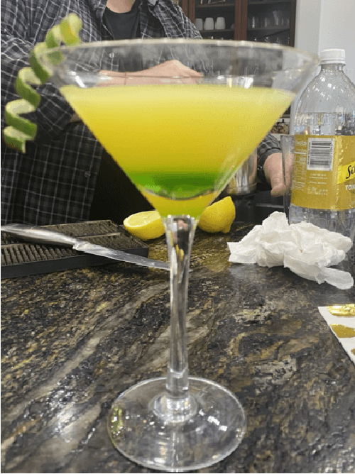 Bright yellow and green casino cocktail in a martini glass