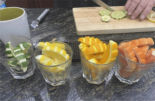 Glasses filled with citrus garnishes with fancy designs in the rinds