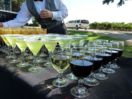 Bartender serving wine, mimosas, and champagne to casino event guests