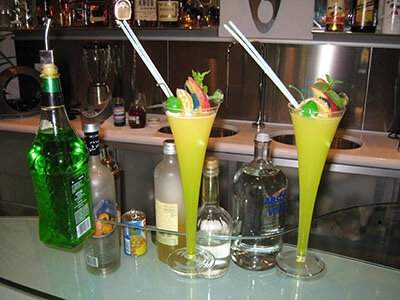 Several brightly colored tropical drinks with straws at a casino event in Fort Worth, TX