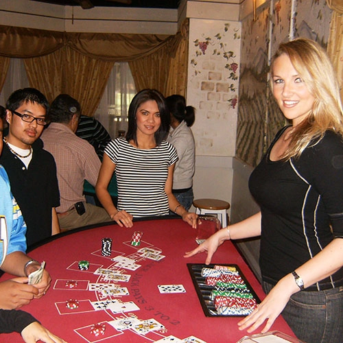 Professional Blackjack dealer dealing cards to guests at a charity event.