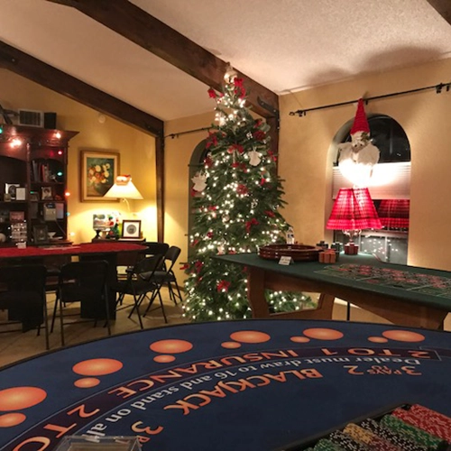 Fancy room with Christmas tree Blackjack, Roulette, Craps, and Pai Gow tables before the party.